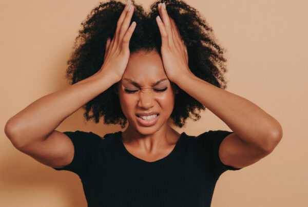 Frustrated woman standing with her hands on her head