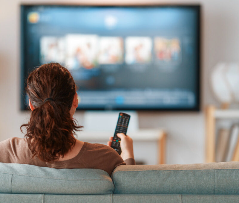 Woman relaxing on her living room floor during a sedentary day