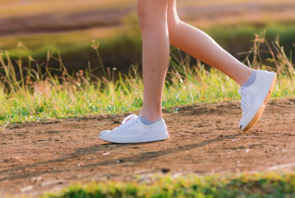 Close-up of a woman's legs walking outdoors