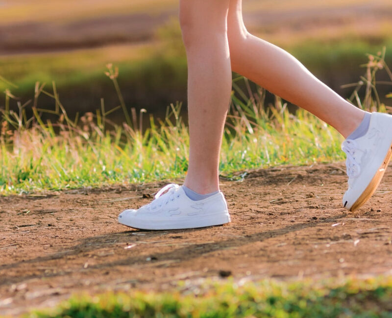 Close-up of a woman's legs walking outdoors