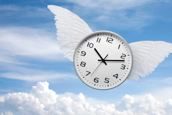 A winged clock symbolizing time flying by