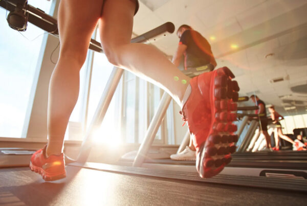 Woman strength training with weights at sunset