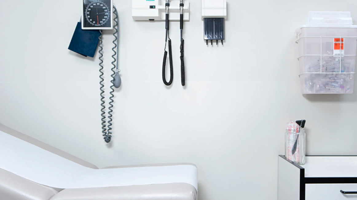 A scale and blood pressure cuff in a doctor's office