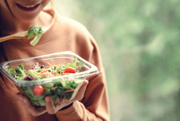 Woman eating a healthy salad from a bowl
