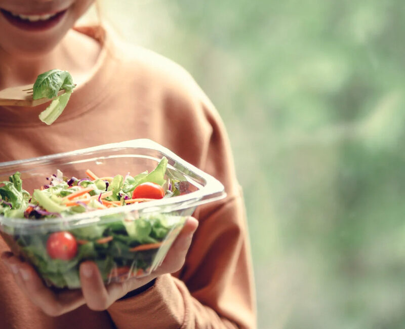 Woman eating a healthy salad from a bowl