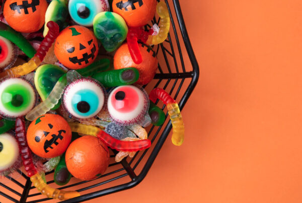 Halloween eyeball candies in a bowl on an orange background