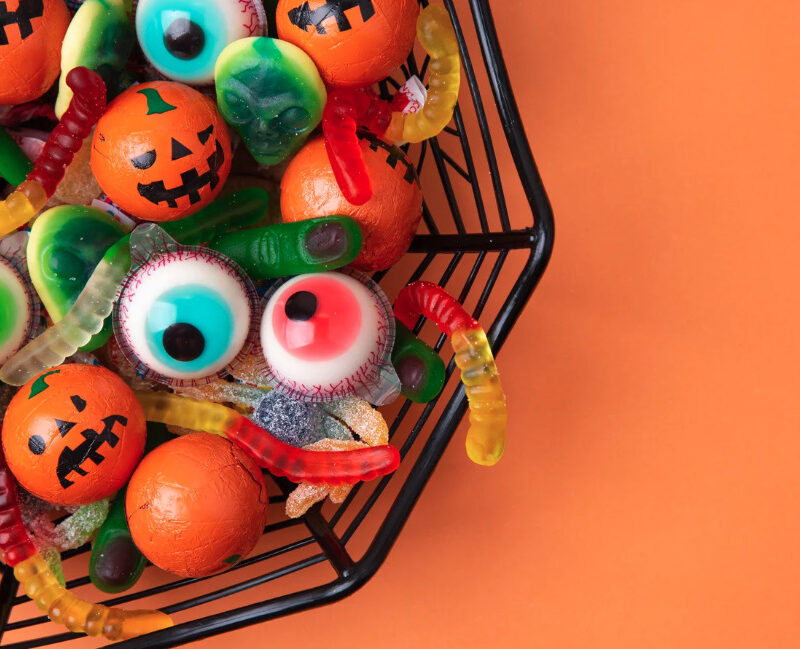 Halloween eyeball candies in a bowl on an orange background