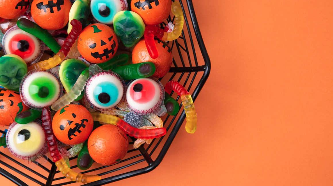 Halloween eyeball candies in a bowl on an orange background